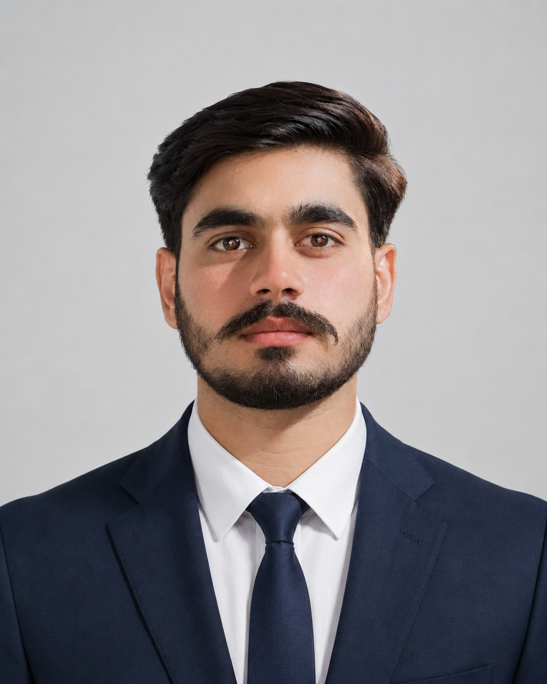 Professional portrait of Seerat Hussain Sial in a navy suit and tie